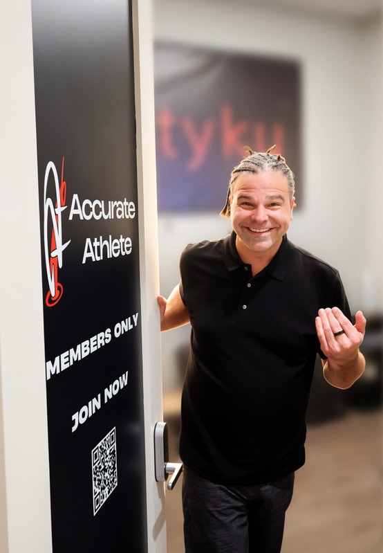 Accurate Athlete owner welcoming a visitor at the studio entrance
